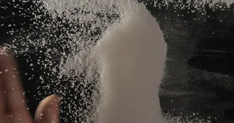 White sugar pouring and mixed with hands from below 4K pro res Stock-Footage 274906880