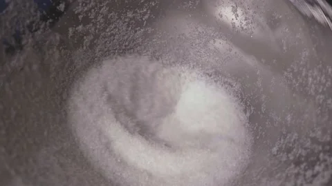 White sugar-like powder falling from a funnel in slow motion Stock Footage 169171002