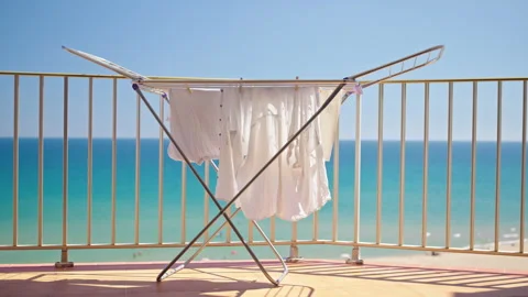 White summer clothes drying on balcony with turquoise sea view Stock Footage 337125128