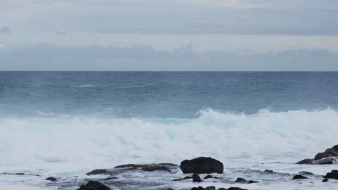 White surf explodes against black shore rocks — moody seascape Stock Footage 315205778