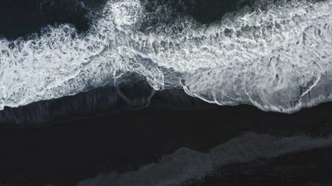 White Surf Patterns Washing Over Black Sand Stock Footage 144133622