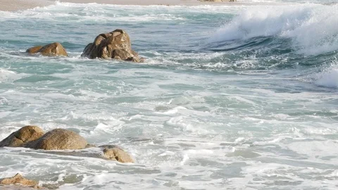 White surf waves on the ocean with rocks jutting from the water. Side view. Stock Footage 104457597