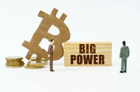 On a white surface, the bitcoin symbol, human figures and a wooden plate with 写真素材