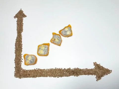 On the white surface, a coordinate axis is plotted with flaxseed. 写真素材
