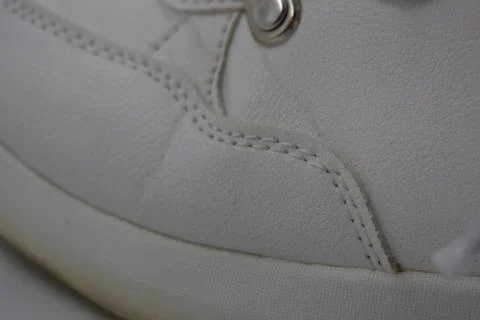 The white surface is stitched with white threads. Stock Photos