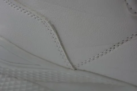 The white surface is stitched with white threads. Stock Photos