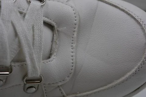 The white surface is stitched with white threads. Stock Photos