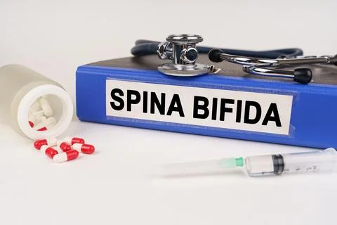 On a white surface there are pills, a syringe and a folder with the inscrip.. Stock Photos