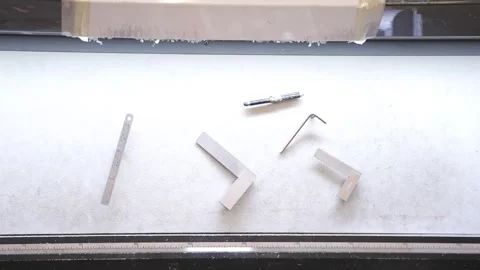 A white surface with a variety of tools including a screwdriver Stock Footage 302456931