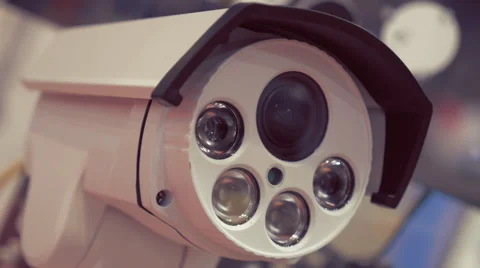 White surveillance camera rotates for checking the surrounding area Stock Footage 64736341