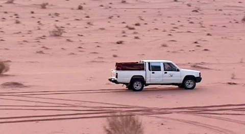 White SUV among red sand dunes. Wadi Rum Desert.White Japanese SUV with tourists Stock Footage 155970304