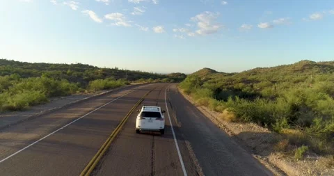 White SUV drives away from under camer. Stock Footage 259432526
