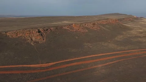 White SUV drives on dirt road, asphalt and rough terrain.  Video stock 304699088