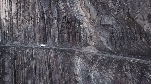 White SUV Driving On The Edge Of A Cliff In A Canyon Stock Footage 102459284