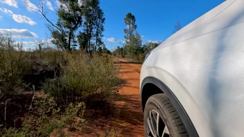 White SUV Driving on Red Dirt Track in Australian Outback Video stock 345012453