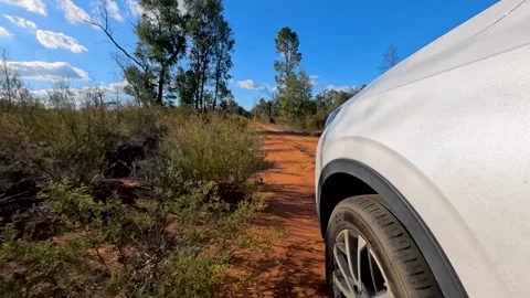 White SUV Driving on Red Dirt Track in The Pilliga Stock Footage 345012636