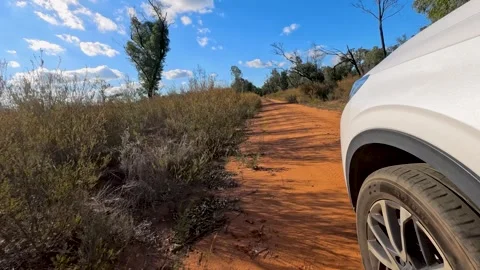 White SUV Driving on Red Dirt Track in The Pilliga Stock Footage 345012699