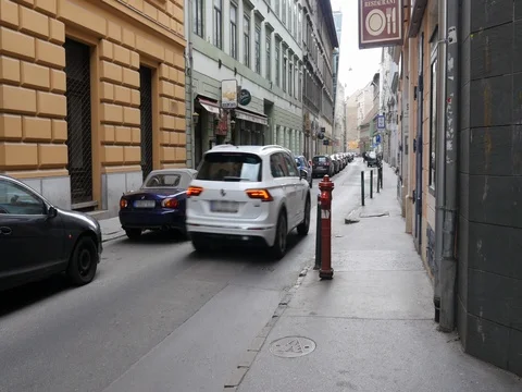 White SUV driving through narrow passage street. Stock Footage 79987568