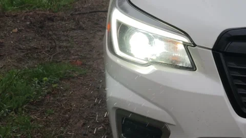 White suv headlight shining through the raindrops Stock-Footage 310408441