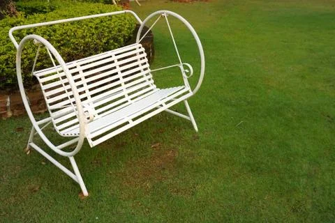 White swing in the garden Stock Photos