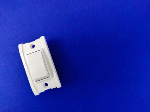 A white switch in off condition on blue background.Copy space Stock Photos