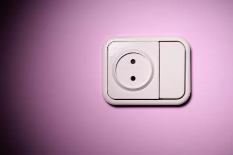 White switch socket on a pink wall. Stock Photos