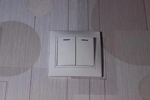 White switch with two keys on the wall Stock Photos