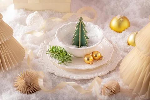 White table arrangement featuring snowy Christmas ornaments. Stock Photos