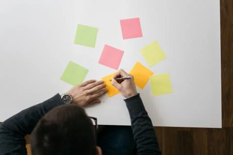 White table with blank colored sticky notes Stock Photos