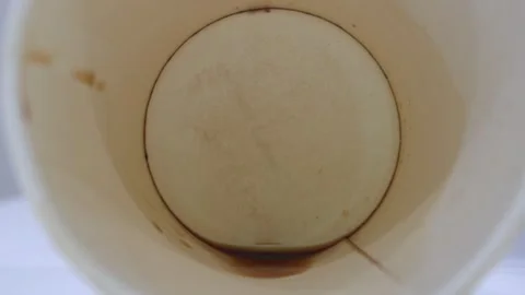 White table close up view last drop of coffee at bottom of paper cup. Video stock 251704853