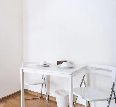 White table with folding chairs set in modern kitchen room mock up Stock Photos