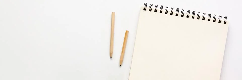 White table at home. Open empty sketchbook, wooden pencils. Mockup. Stock Photos