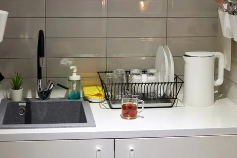 White table modern kitchen with cutting board kettle and utensils. Stock Photos