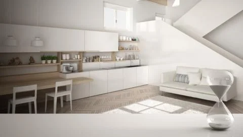 White table or shelf with crystal hourglass measuring the passing time over m Illustrazione stock