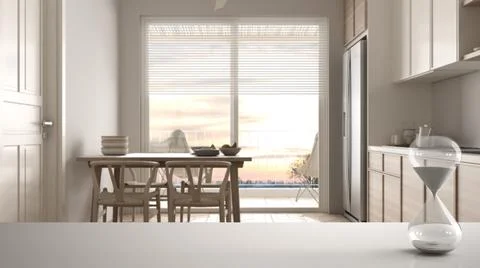 White table or shelf with crystal hourglass measuring the passing time over s Illustrazione stock