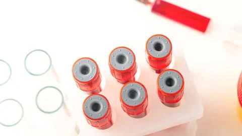 A white table with a red container with a red liquid in it Stock Photos