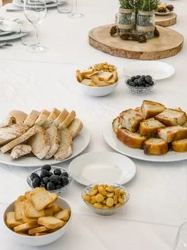 A white table is set with a selection of savory appetizers for guests Stock Photos