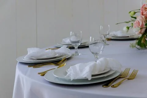 White table setting plate, napkin and glass. Stock Photos