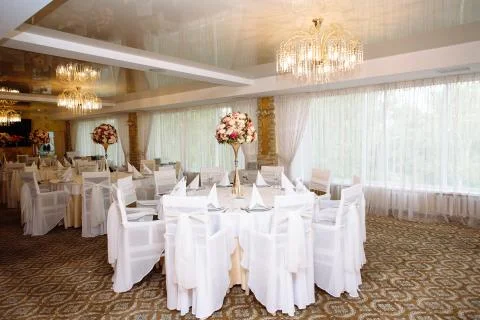 White table setting at wedding reception, clean tables with flowers and no food Stock Photos