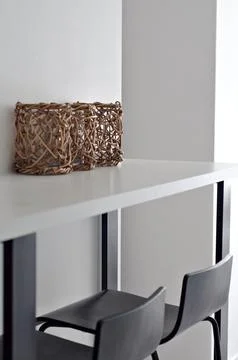White table-shelf in a narrow kitchen. Modern interior. black chairs. Stock Photos