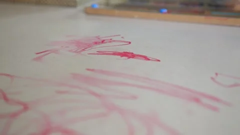 White table with signs of red marker and drawing supplies Stock Footage 301384191
