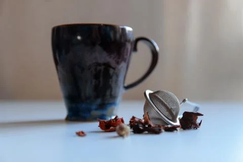 White table tea composition. Red tea strainer. Stock Photos