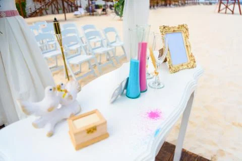White table for a wedding ceremony with decorations on the seashore. Stock Photos