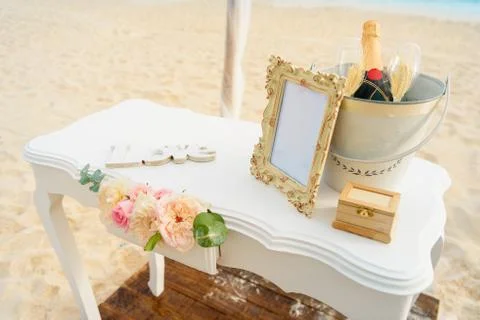 White table for a wedding ceremony with decorations on the seashore. Stock Photos