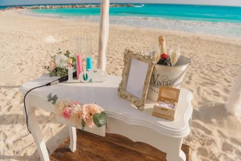 White table for a wedding ceremony with decorations on the seashore. Stock Photos