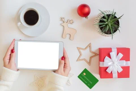 On a white table a woman's hands with a digital tablet Stock Photos
