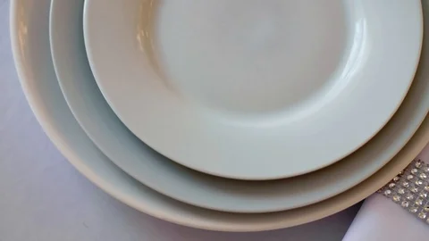 White tablecloth served plates wine glasses and napkins Stock Footage 97718351
