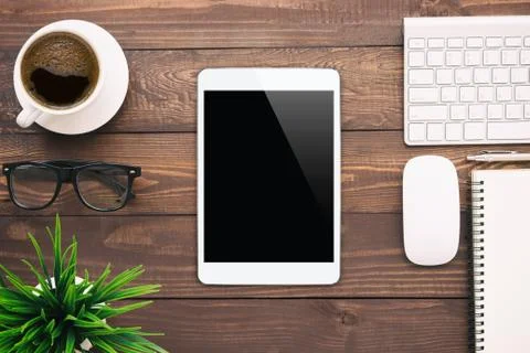 White tablet blank screen on work desk Stock Photos