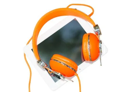 White tablet computer with orange headphones isolated on white Stock Photos