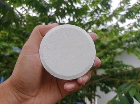 White tablet held in human hand Stock Photos
